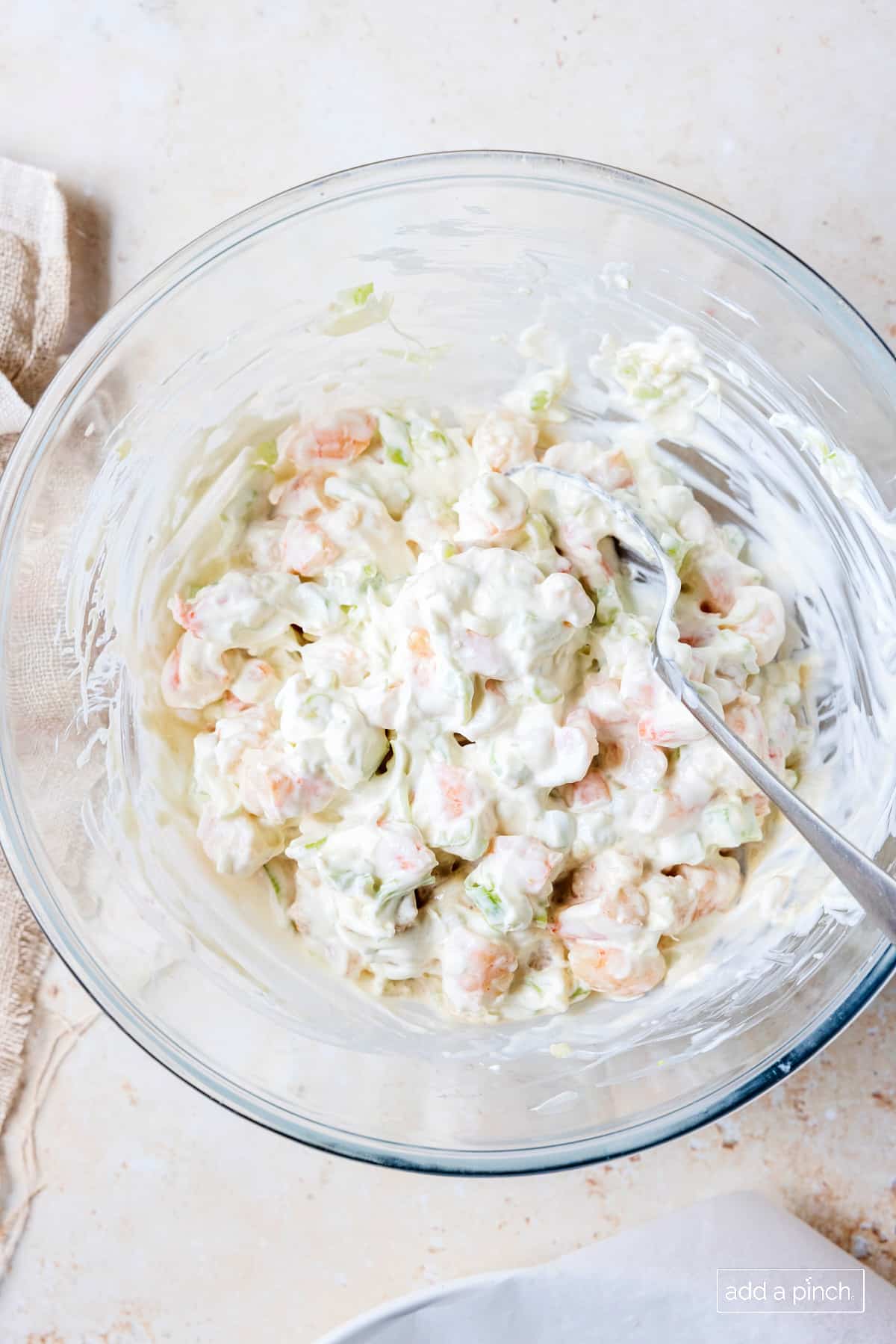 Shrimp dip stirred together in a glass bowl.