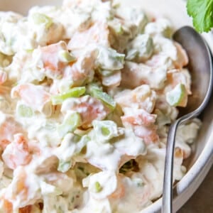 Shrimp dip in a white bowl with a spoon for serving.