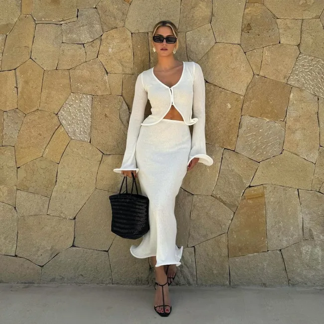 woman wears white knit set