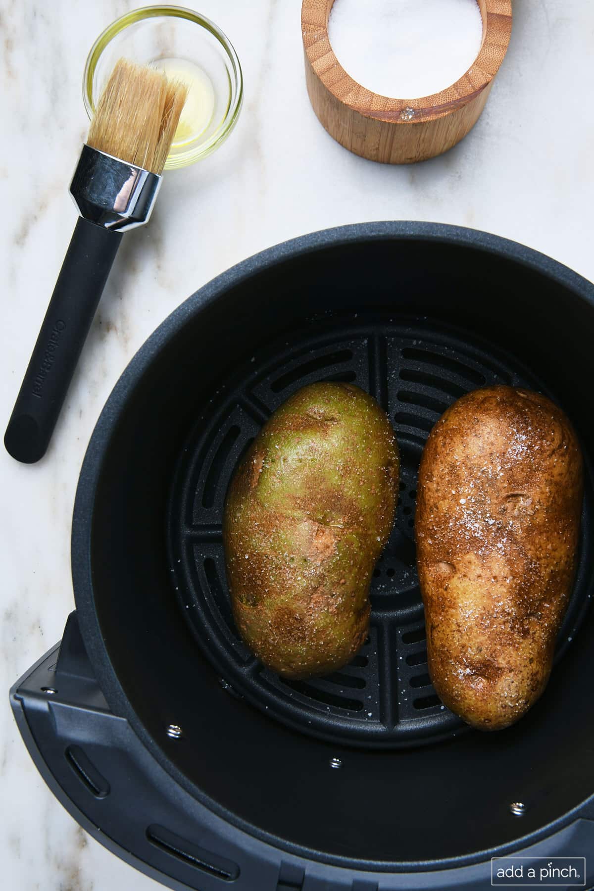 Potatoes in air fryer basket.