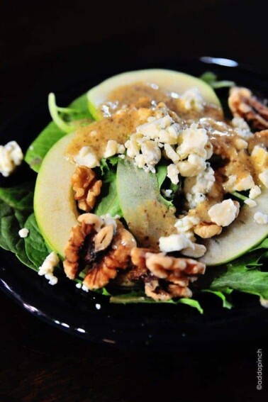 Apple Walnut Salad - Apple Walnut Salad is a delicious blend of spinach, tart juicy apples, walnuts and creamy bleu cheese crumbles. It is simply perfect for fall. // addapinch.com