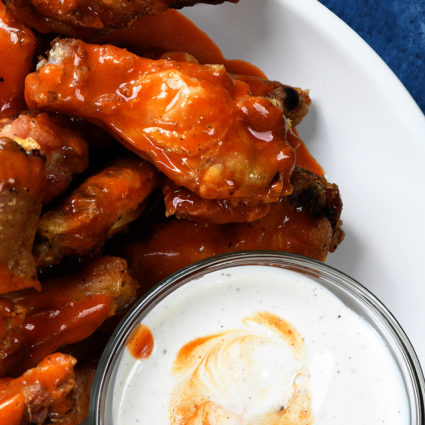 Baked Crispy Buffalo Chicken Wings Recipe - Crispy buffalo wings no longer have to be deep fried to be delicious! This easy recipe for baked chicken wings makes everyone's favorite wing even better! // addapinch.com