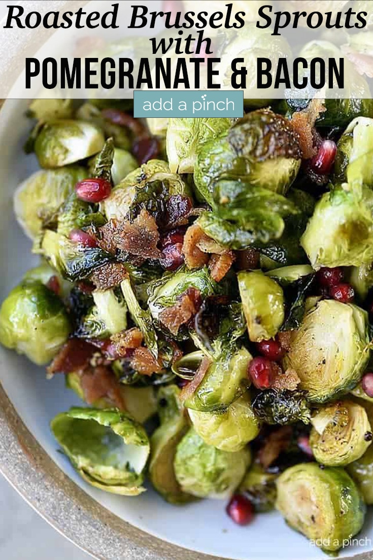 Roasted Brussels Sprouts with Bacon and Pomegranate in white serving dish - with text - addapinch.com