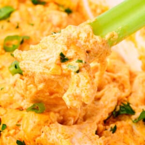 Celery dipped into cheesy buffalo chicken dip.