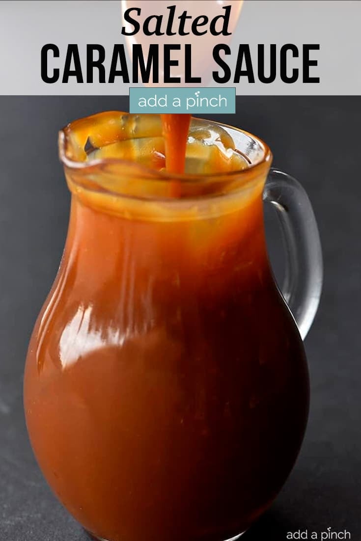 Salted Caramel Sauce in glass pitcher, being drizzled in with with a spoon - with text.