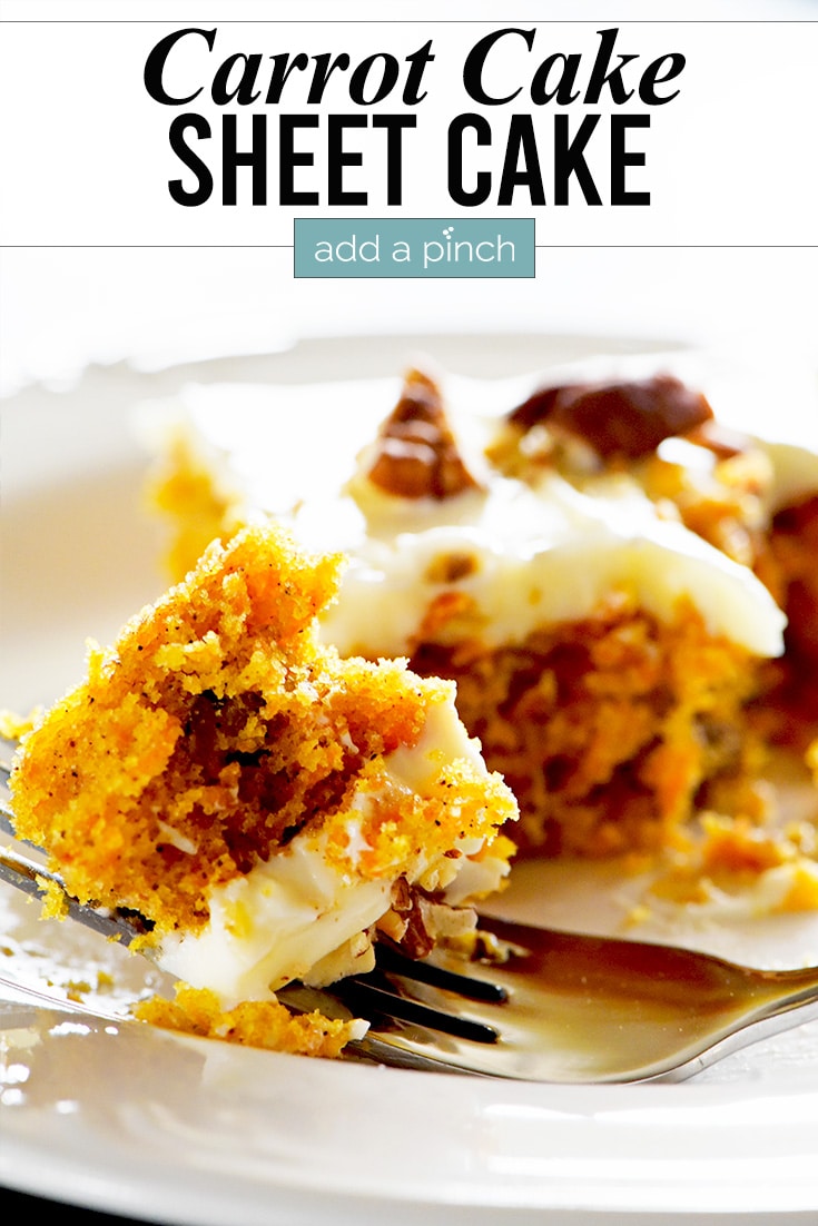 Bite of carrot cake topped with cream cheese frosting on a white plate. | addapinch.com