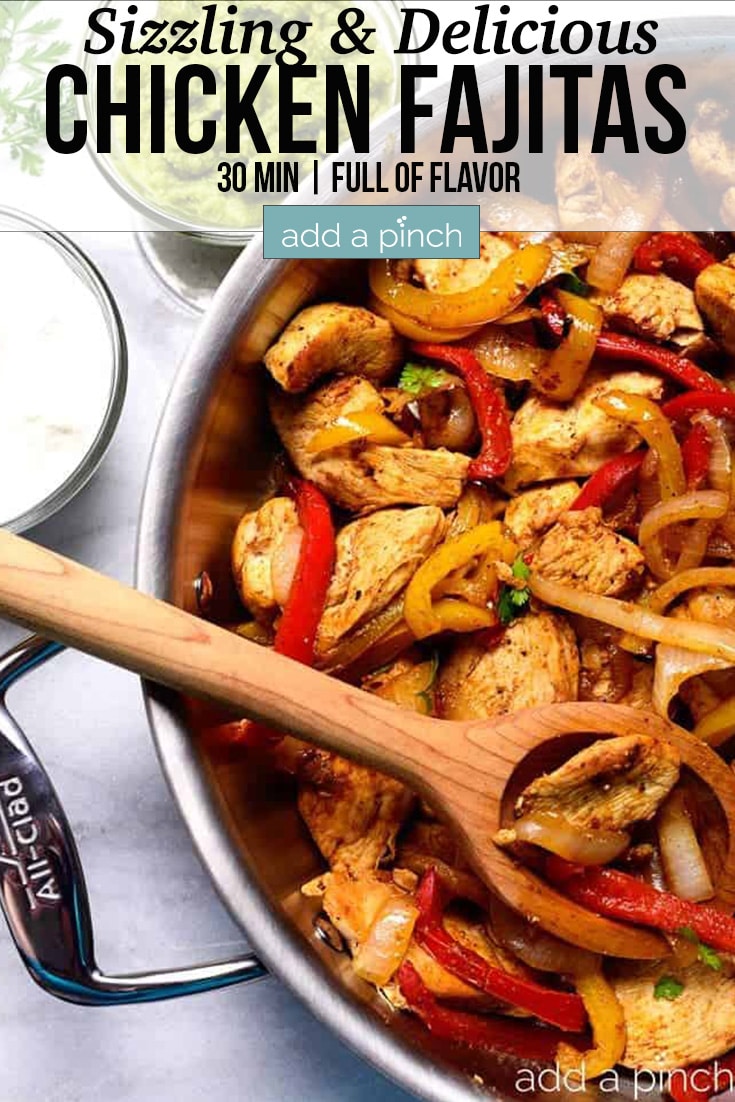 Chicken Fajitas in a stainless skillet with wooden spoon - with text - addapinch.com