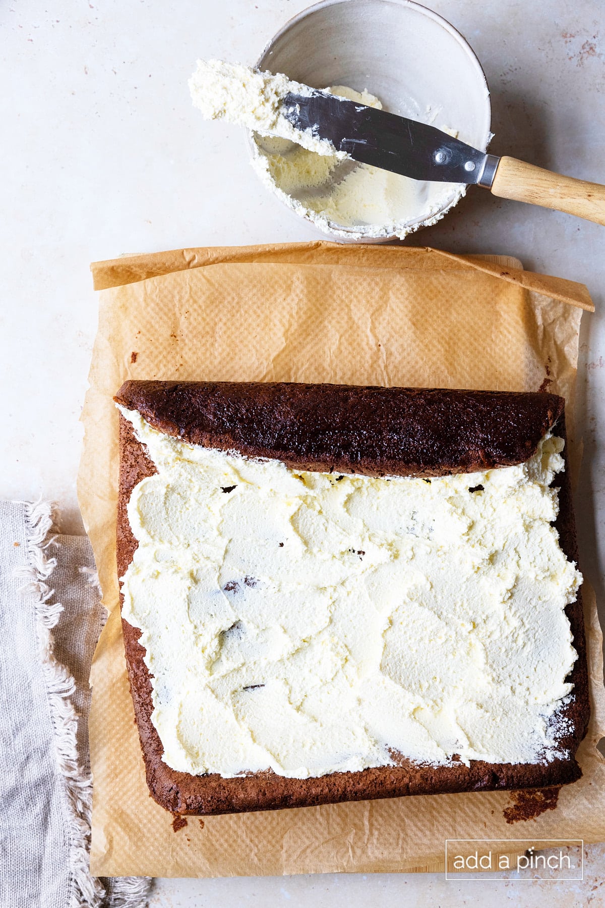 Sweetened whipped cream filling spread onto the cooled chocolate cake.