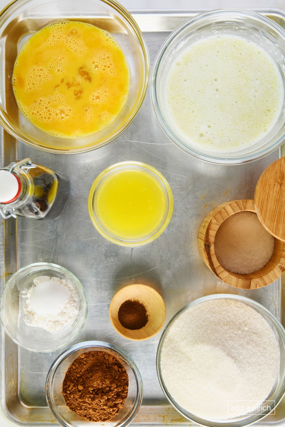 Photo of ingredients used to make chocolate chess pie on a rimmed baking sheet. 