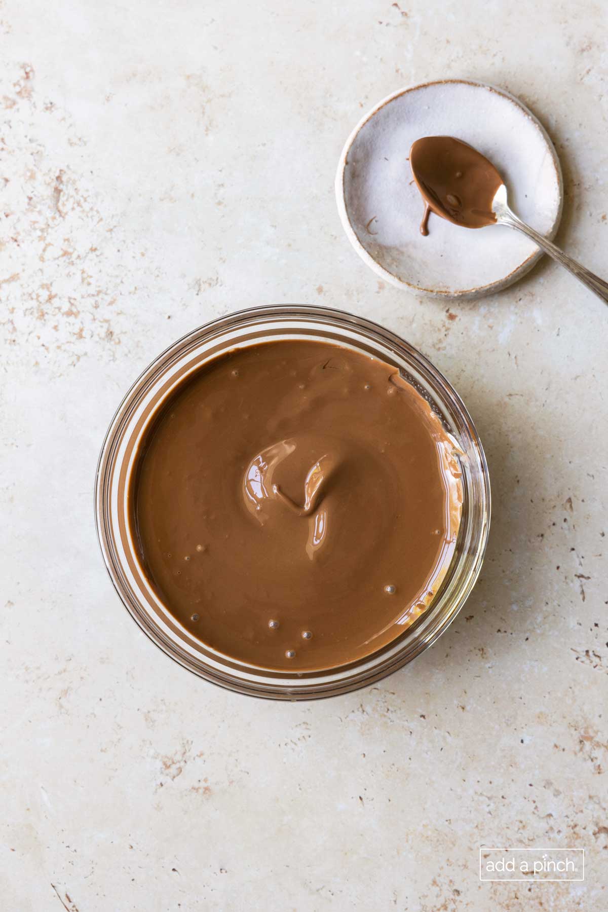 Melted chocolate in a glass bowl.