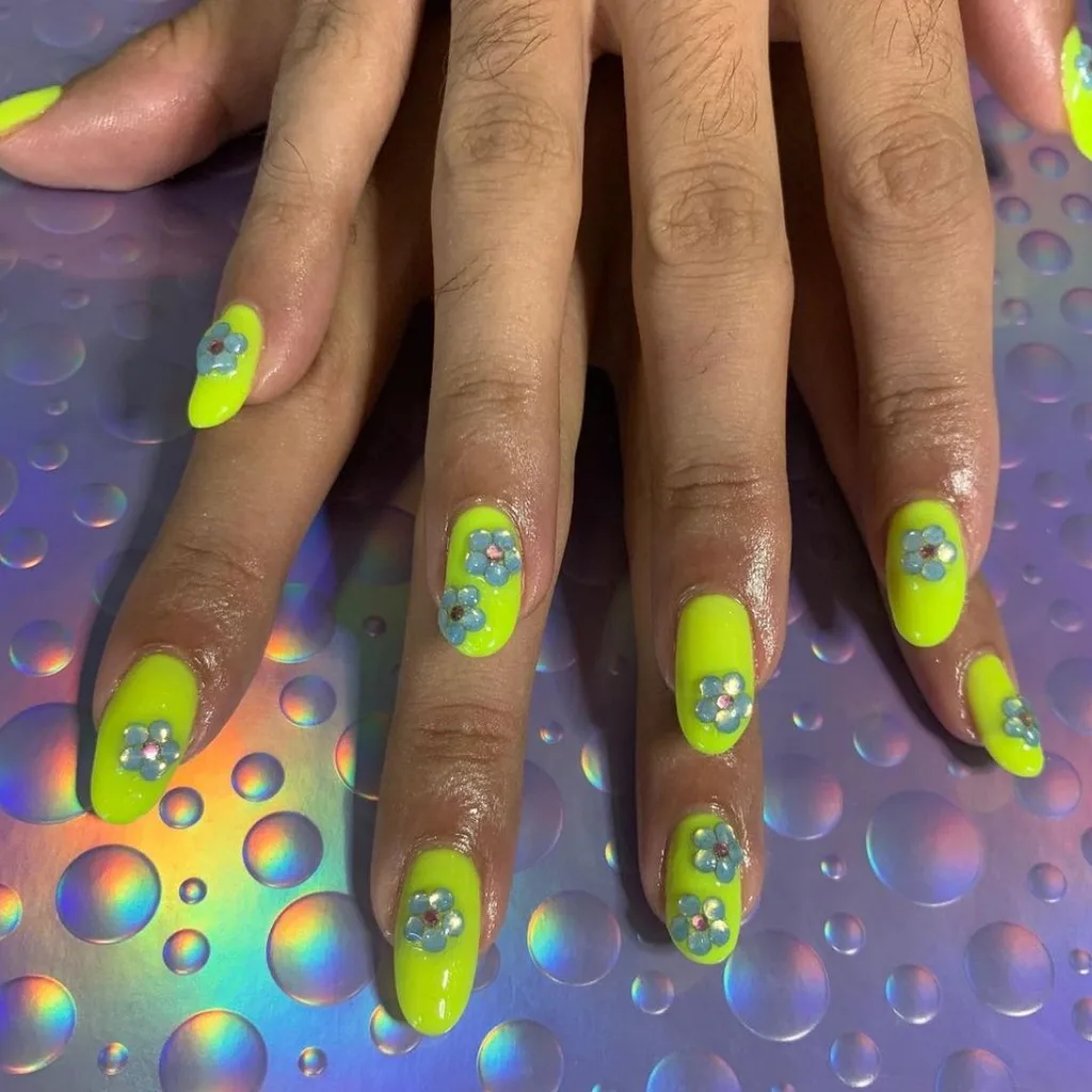 Flourescent green nails with 3D sapphire blue flower detail