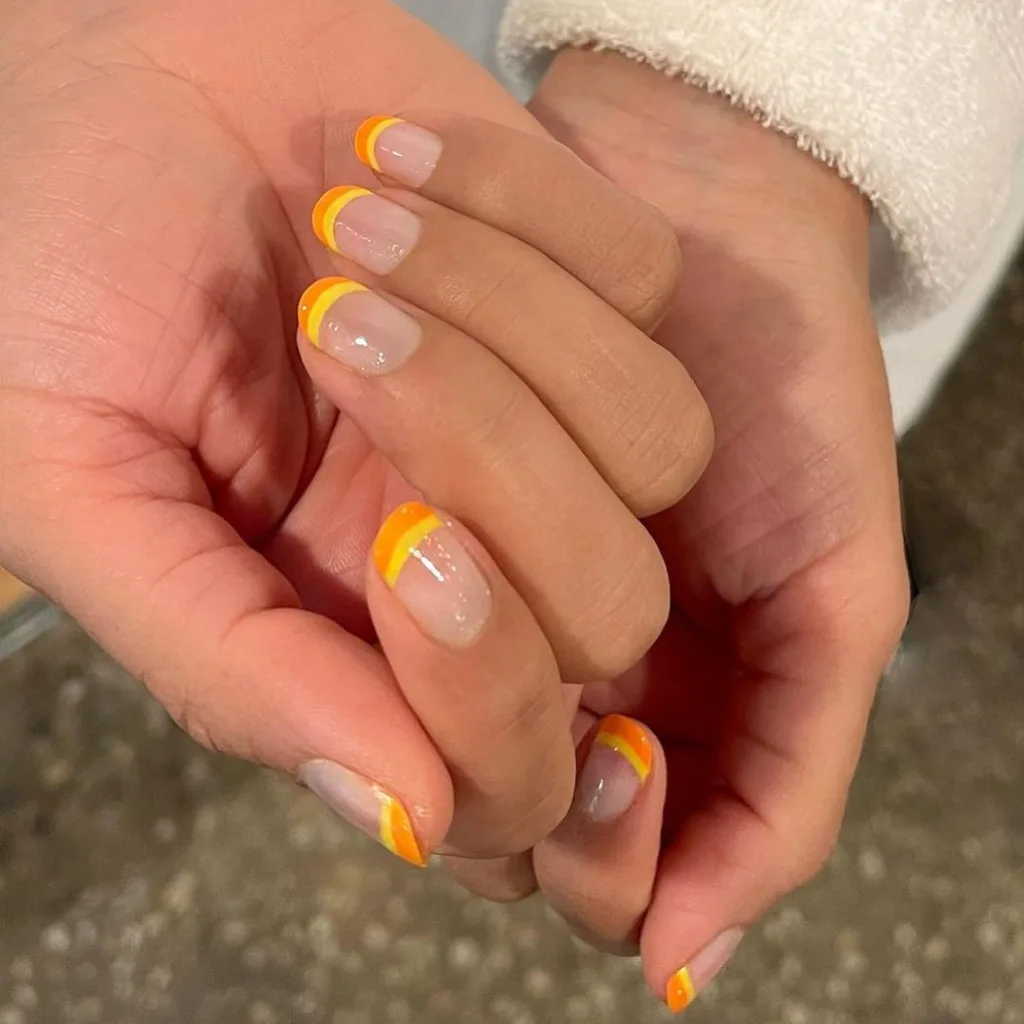 Sunny yellow and orange tipped manicure 