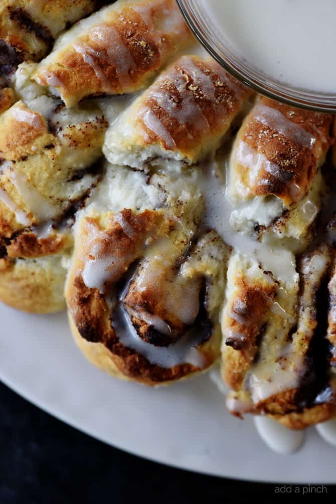 Closeup of Cinnamon Roll Biscuit Wreath drizzled with icing. 