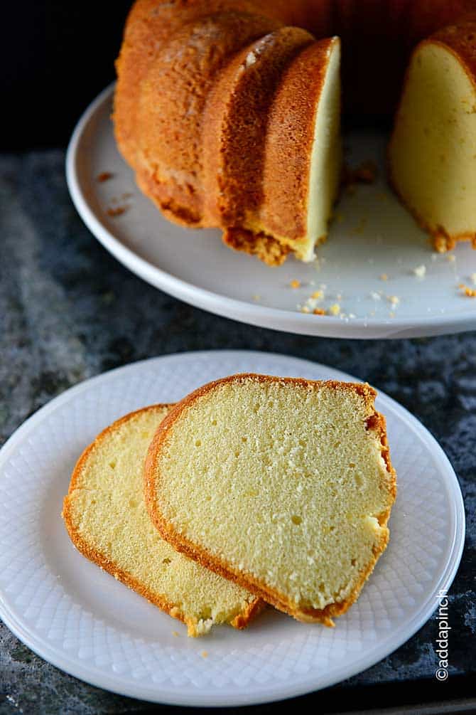 Plate holds pound cake made in bundt pan with a couple slices removed and placed on a white plate.