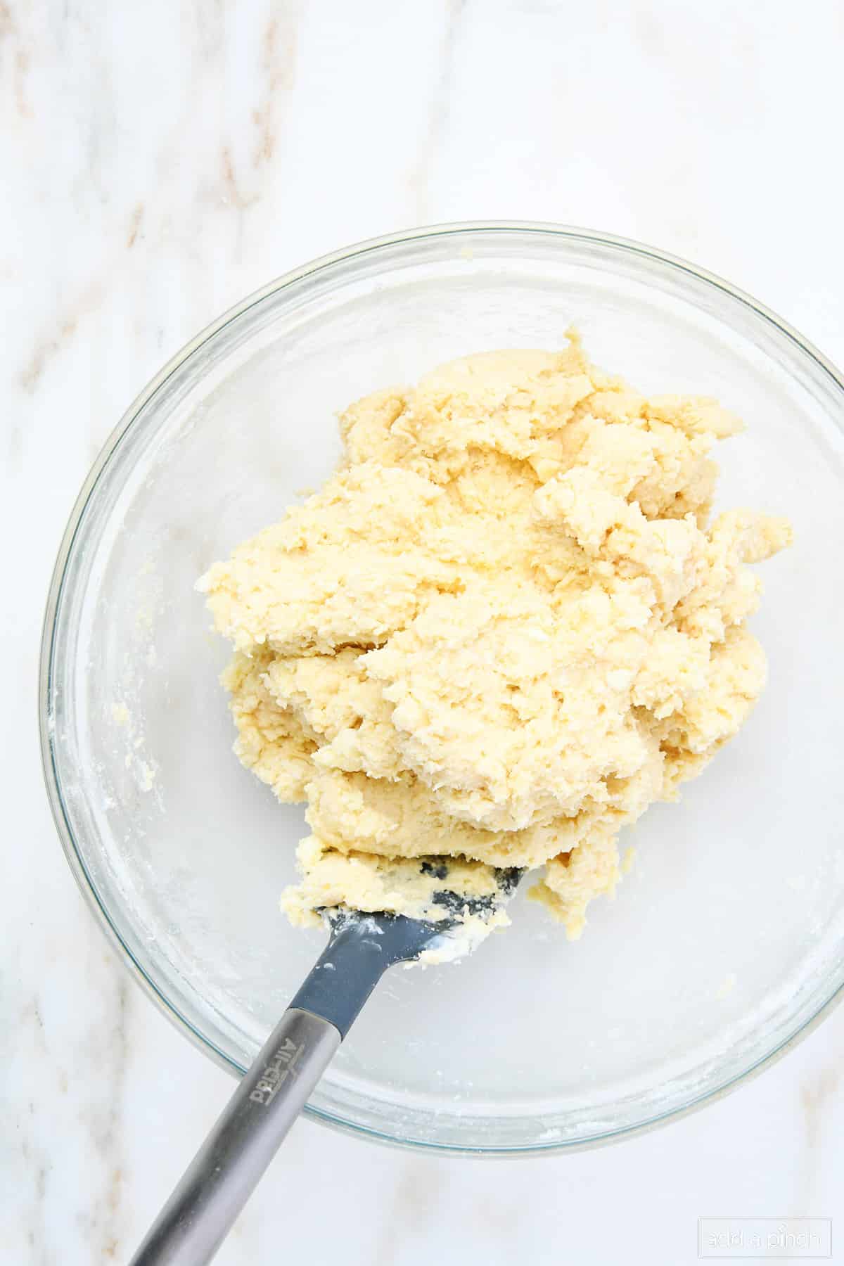 Scones dough mixed together in a glass bowl.