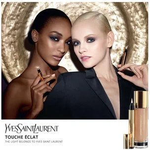 "Two models showcasing Yves Saint Laurent's Touche Éclat makeup products against a textured golden backdrop."