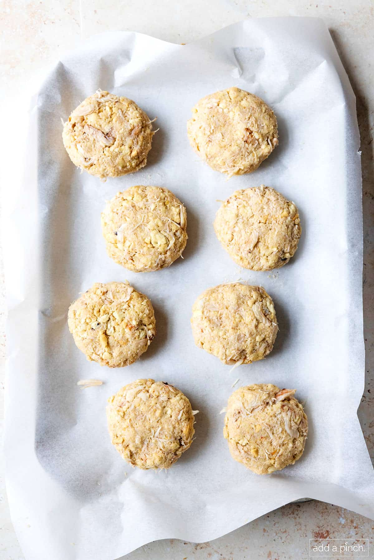 Baking sheet with wax paper holds 8 formed crab cake patties.