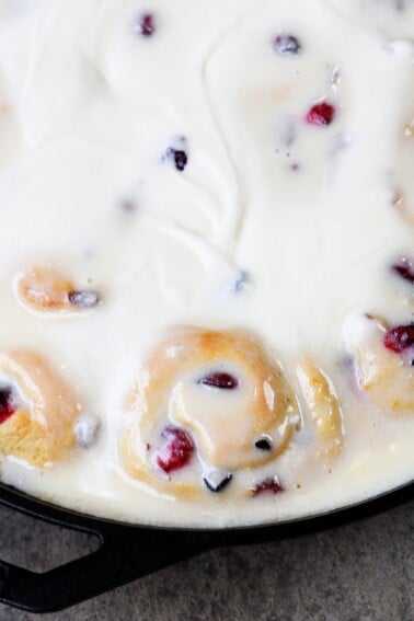 Cranberry Orange Rolls Recipe - The perfect blend of sweet and tart comes together in these easy Cranberry Orange Rolls! Topped with Orange Cream Frosting! // addapinch.com