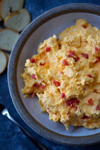 Southern Pimento Cheese Recipe - A staple spread in Southern home and parties, pimento cheese is a classic! Made with cheddar cheese, pimentos and a secret ingredient, this pimento cheese recipe is always a hit! // addapinch.com