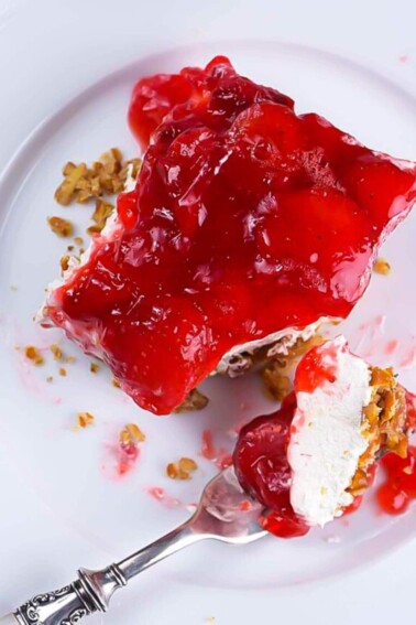 Strawberry Pretzel Salad on plate with fork - addapinch.com