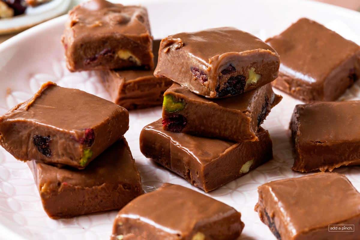 Photo of fudge with mixed nuts and fruit on a plate.