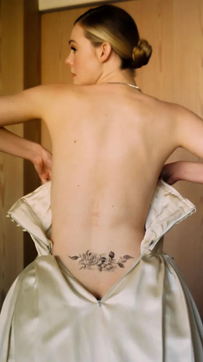 elle fanning fake tramp stamp lower back tattoo