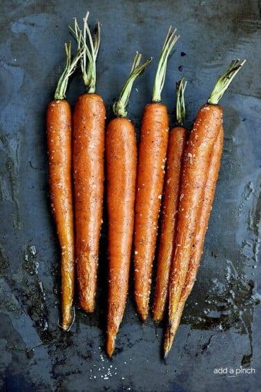 Garlic Roasted Carrots Recipe - Garlic Roasted Carrots recipe make a quick, easy and delicious carrot recipe! The perfect side dish for easy weeknights as well as when entertaining! // addapinch.com