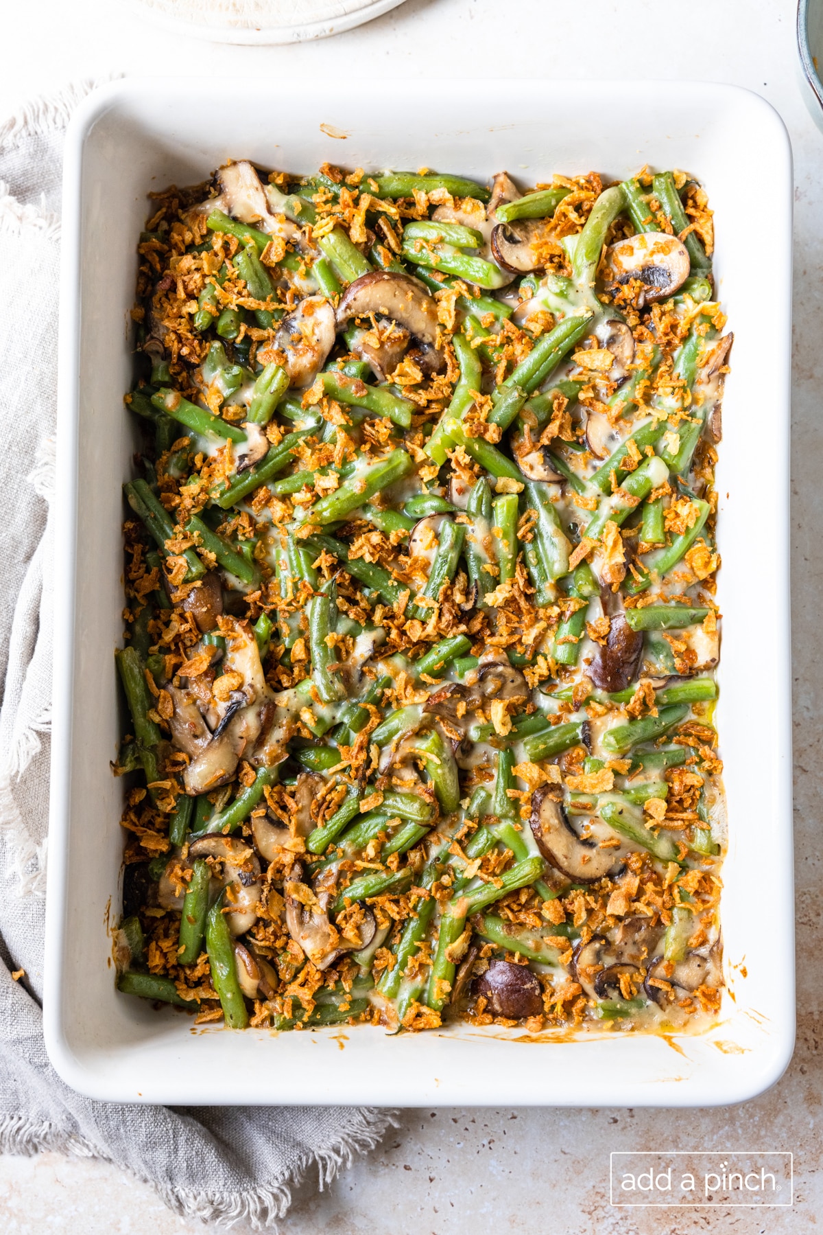 Green bean casserole with topping ready for final baking.