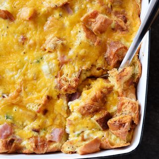 Ham and Cheese Croissant Casserole Recipe - An easy and delicious breakfast casserole that everyone loves! Made of ham, two cheeses, and buttery croissants and baked to perfection! // addapinch.com