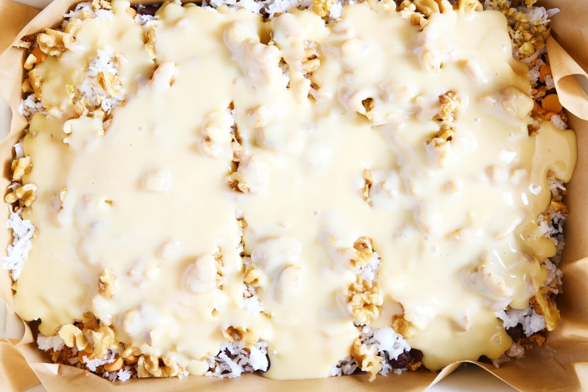 Sweetened condensed milk poured over the cookie bars