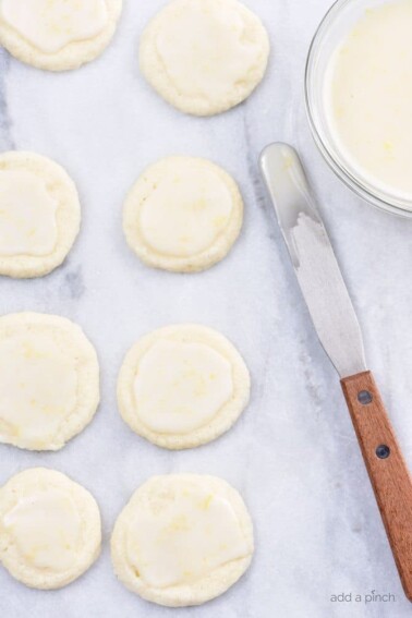 Lemon Shortbread Cookies Recipe - Lemon Shortbread Cookies make a delicious slice and bake cookie recipe perfect for sharing! Made with fresh lemons, this cookie recipe has just the perfect amount of sweet and tart that lemon lovers adore! // addapinch.com