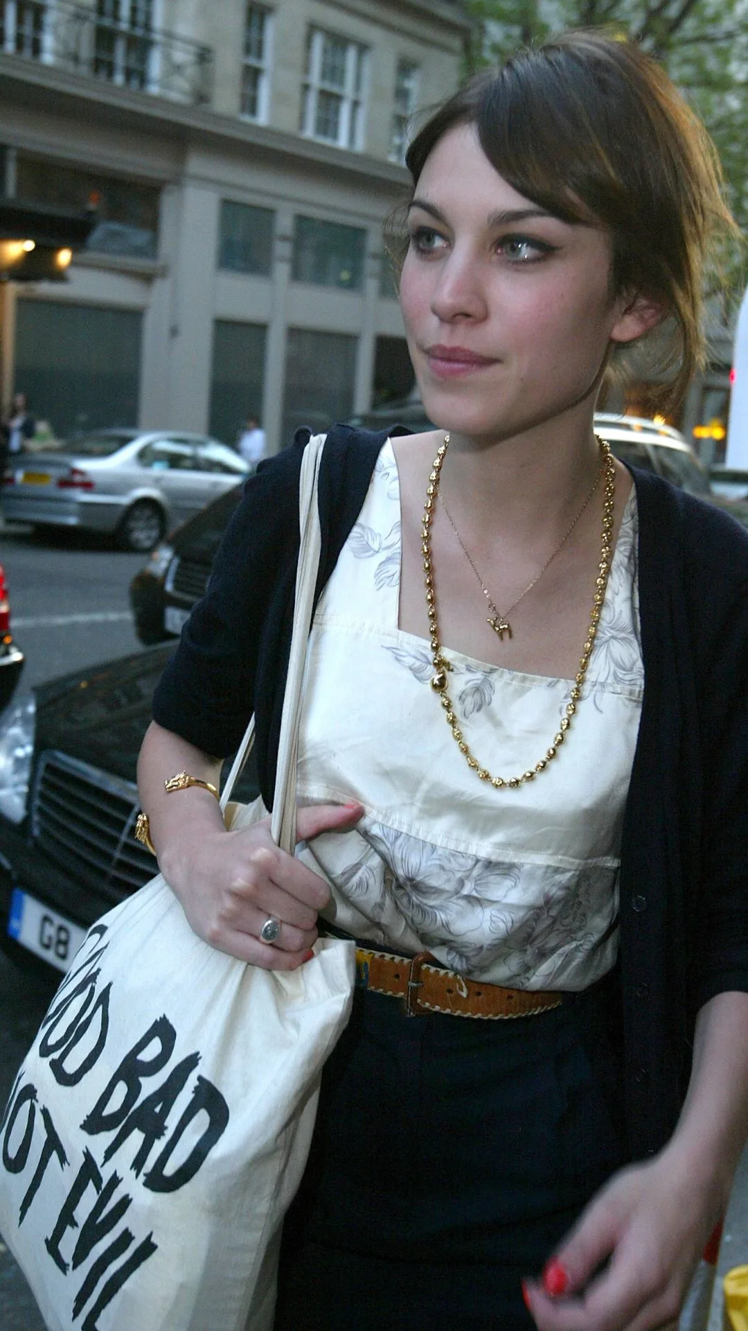 millennial fashion icon alexa chung wearing a vintage top, cardigan and carrying a tote bag