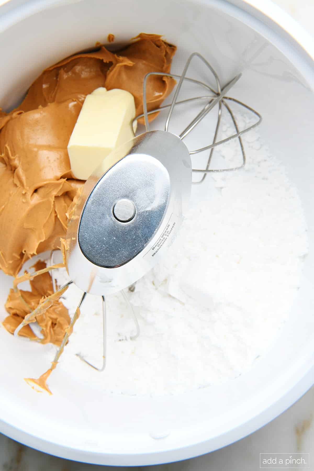 Ingredients for peanut butter balls in an electric mixer.