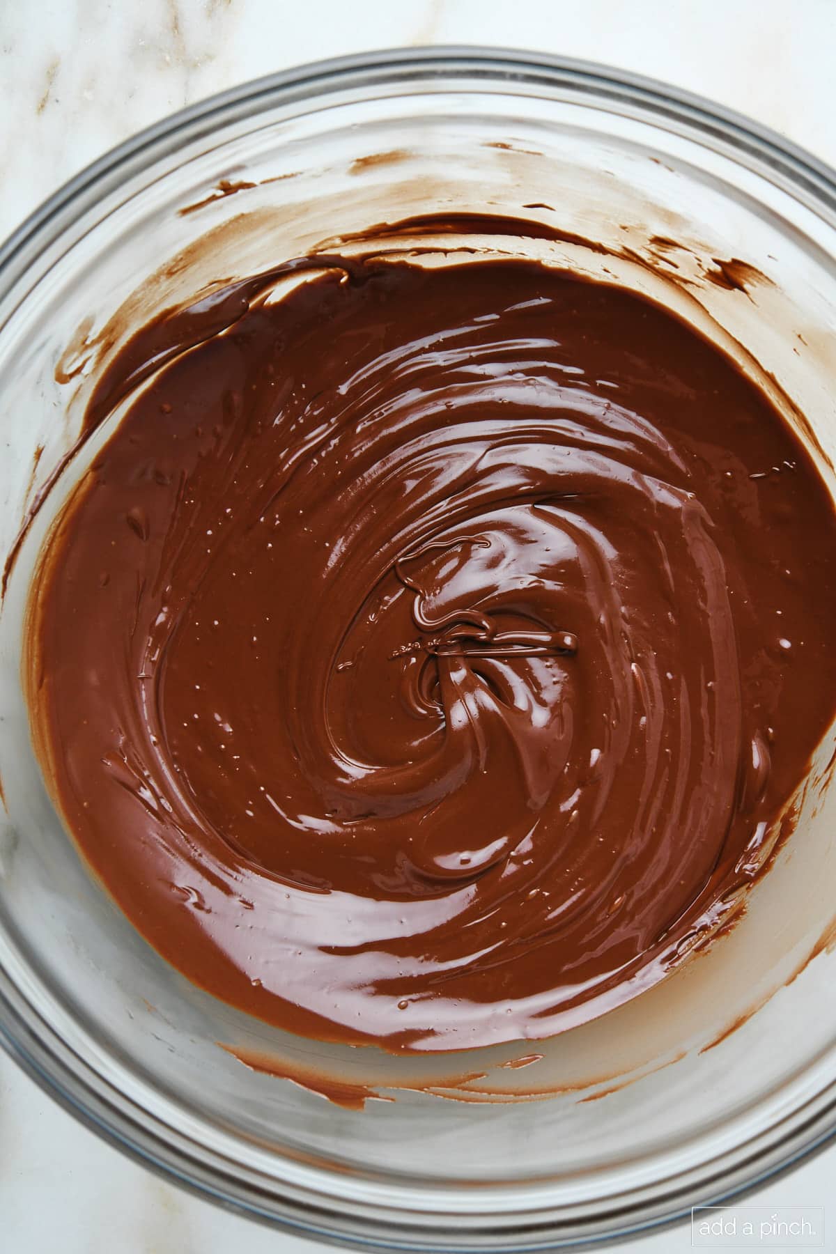 Melted chocolate in a glass bowl.