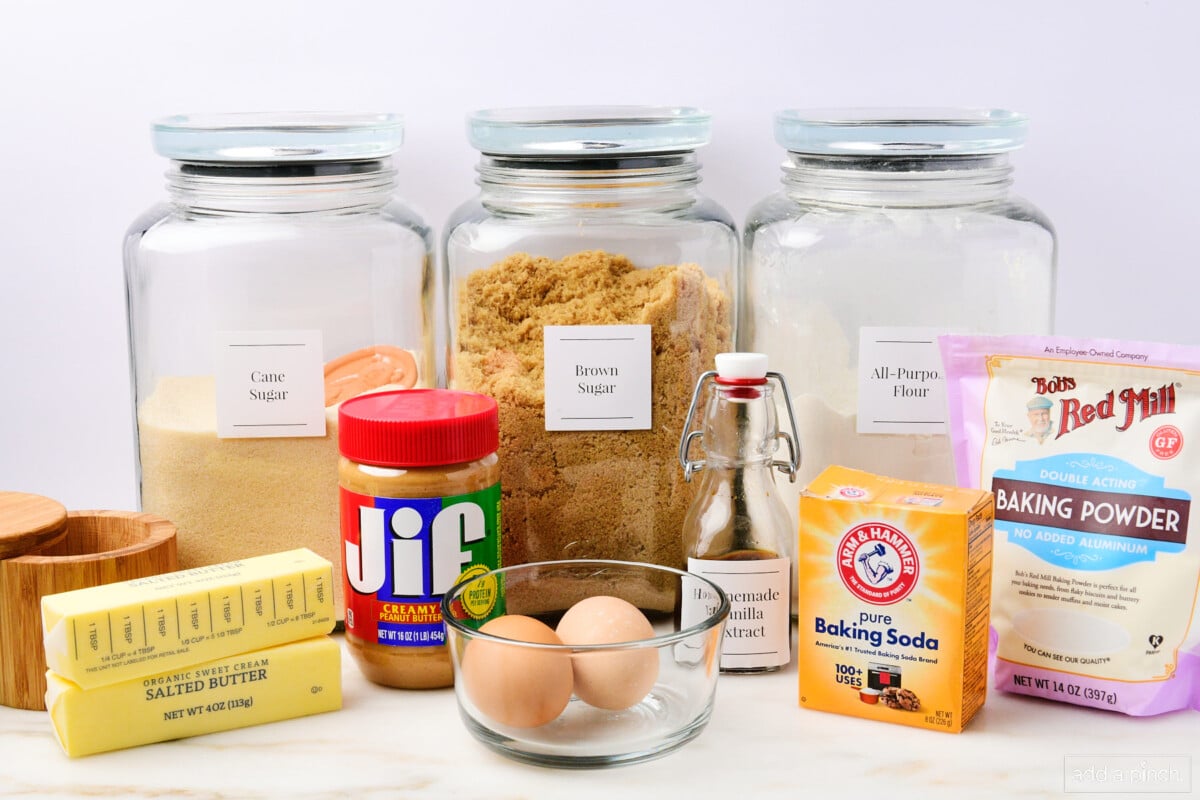 Brown and cane sugar, all-purpose flour, baking soda, baking powder, vanilla extract, eggs, butter, salt, and peanut butter to make cookies.