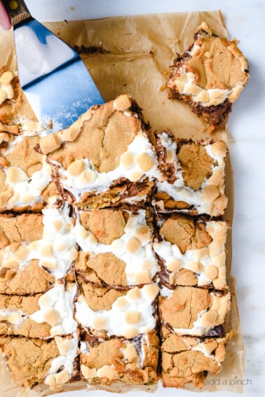 Smores blondies make an easy way to enjoy everyone's favorite campfire treat without having to camp! These smores bars are made with a delicious peanut butter blondie crust! // addapinch.com