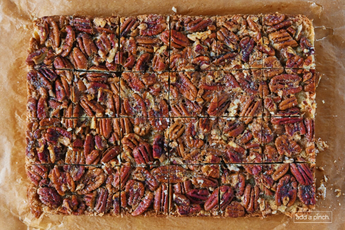 Pecan pie bars on a parchment paper.