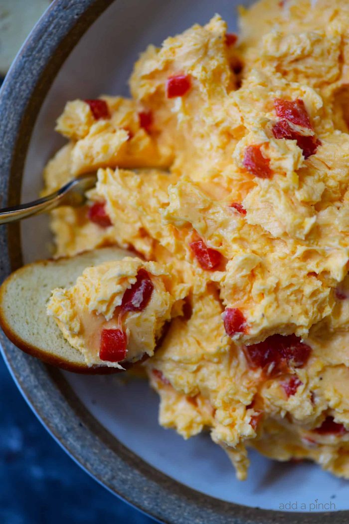 Southern Pimento Cheese Recipe - A staple spread in Southern home and parties, pimento cheese is a classic! Made with cheddar cheese, pimentos and a secret ingredient, this pimento cheese recipe is always a hit! // addapinch.com