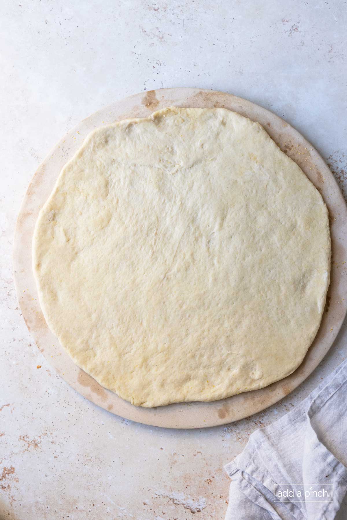 pizza dough on a pizza stone