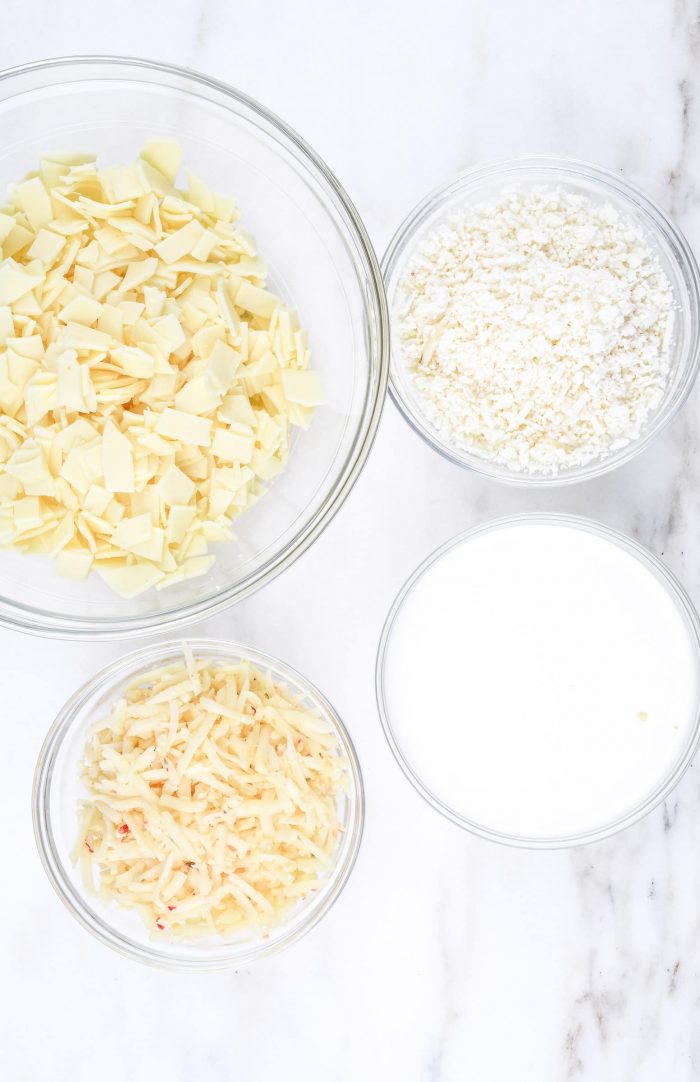 Cheeses in clear bowls on marble counter // addapinch.com