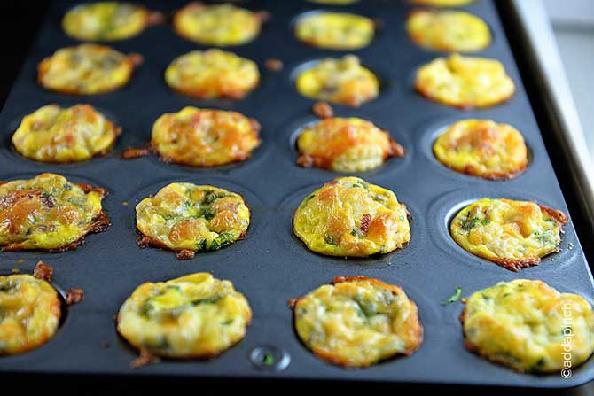 Rows of golden brown Mini Quiche in a mini muffin tin. 