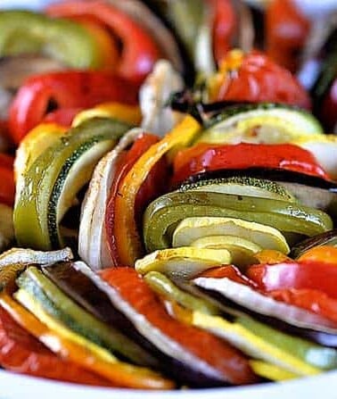 White pie plate filled with various fresh, colorful vegetables. // addapinch.com