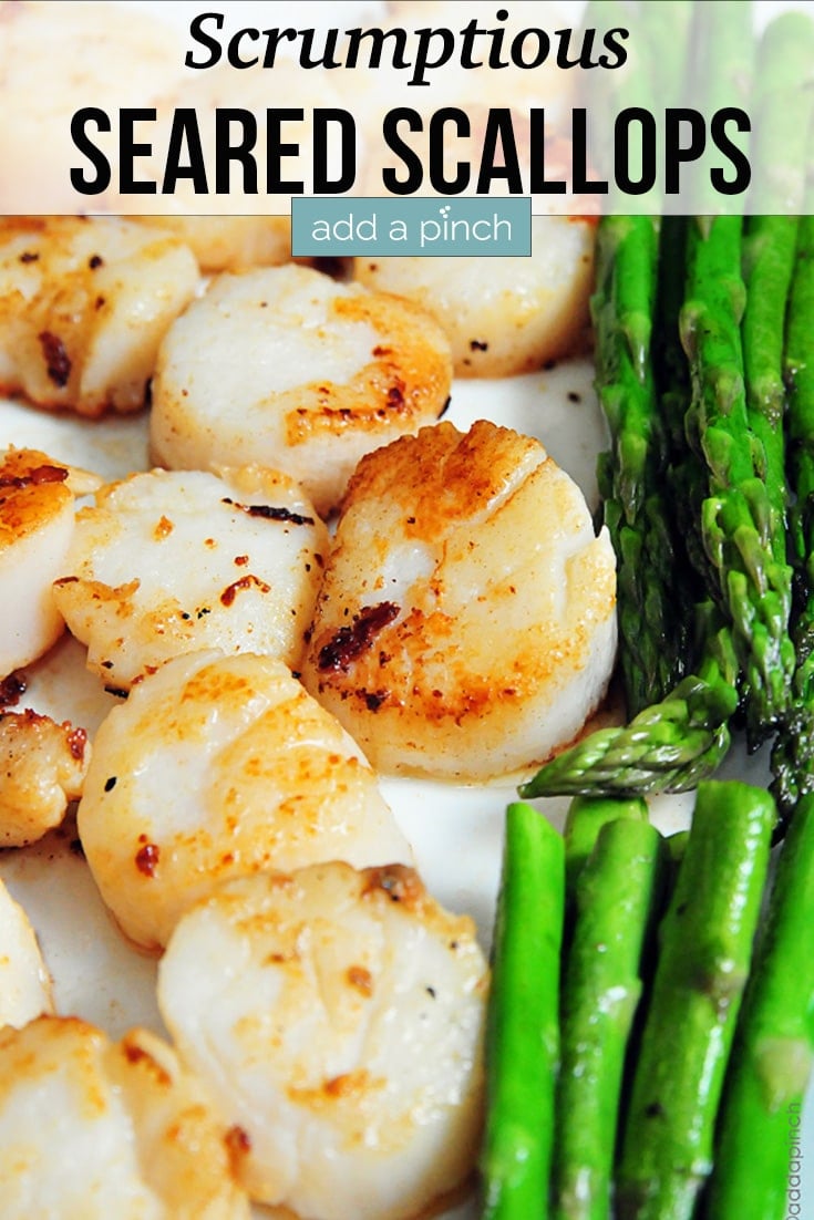 Seared Scallops on tray with steamed asparagus - with text - addapinch.com