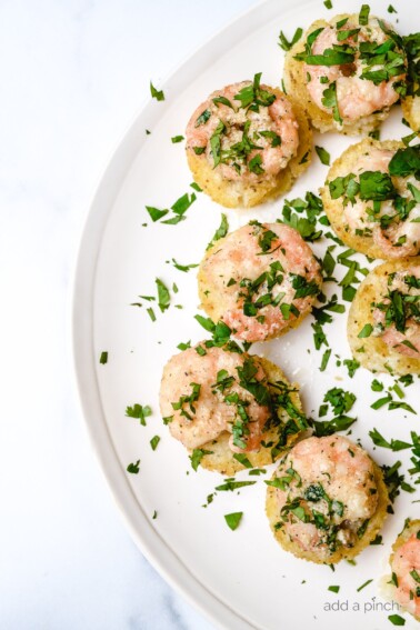 Shrimp and Grits Bites are a bite-sized version of the all-time favorite shrimp and grits. Made in a mini muffin tin and perfectly portioned for entertaining, parties, tailgates and more! // addapinch.com