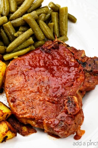 Slow Cooker BBQ Pork Chops - The slow cooker makes these pork chops fork tender and a family favorite! Just 5 minutes of prep time make this a favorite weeknight meal! // addapinch.com