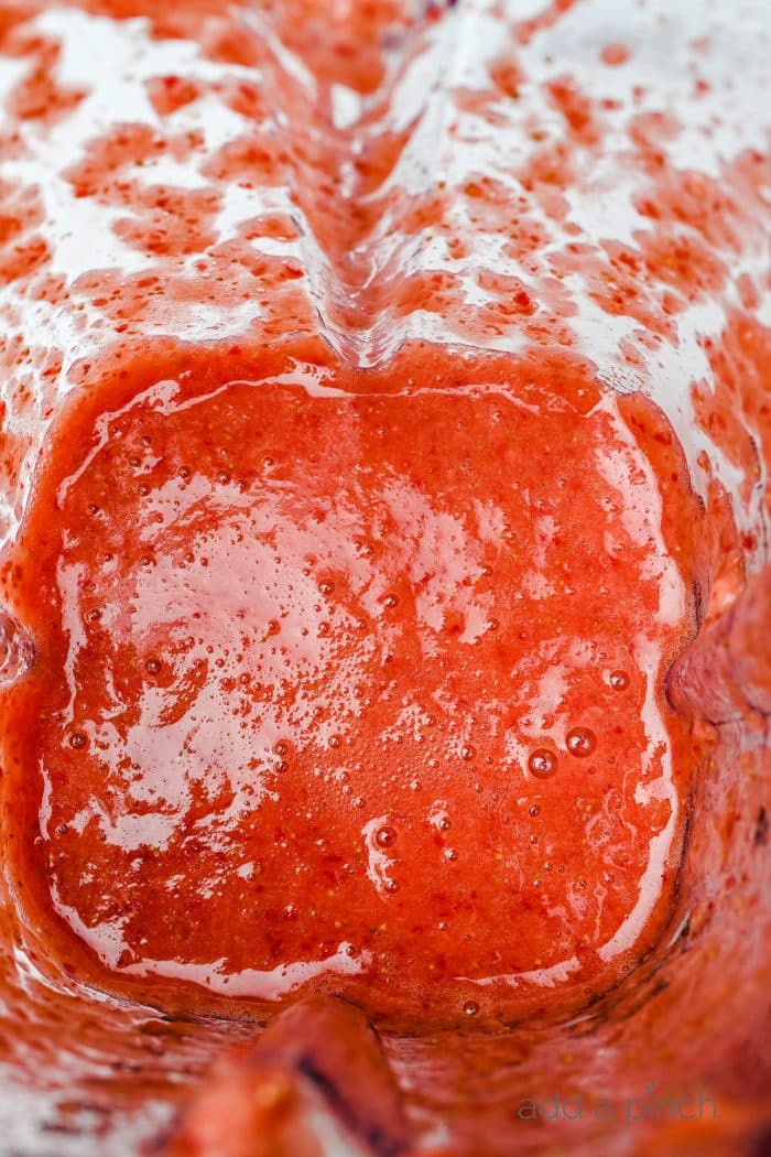 Blended strawberry puree in a blender jar.  // addapinch.com