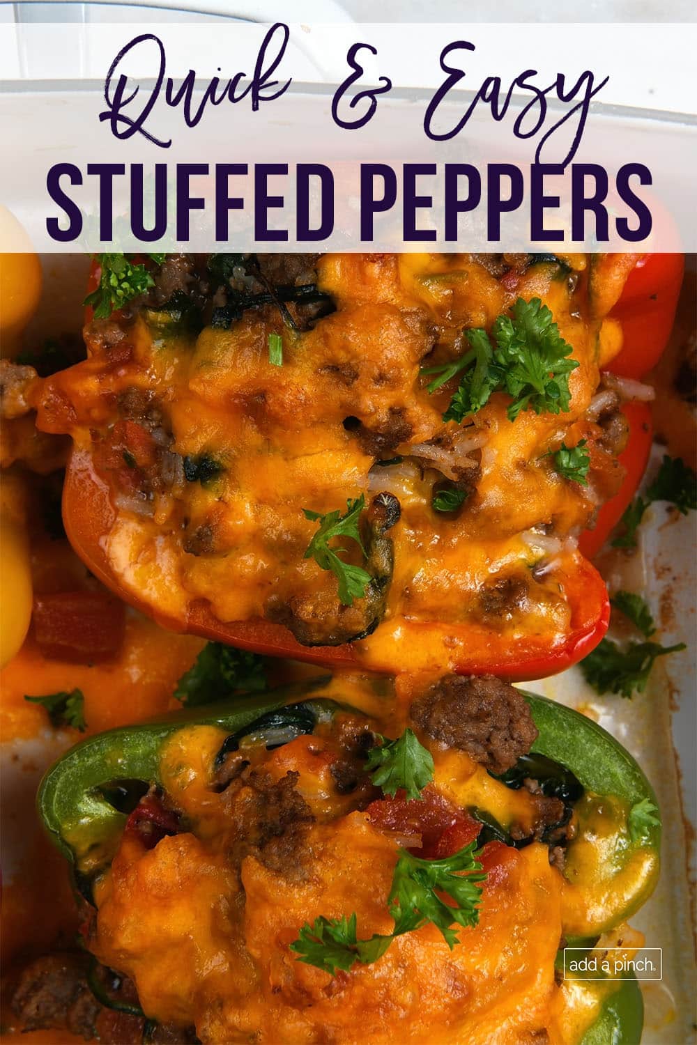 Cheesy green and red stuffed peppers in baking dish - with text - addapinch.com