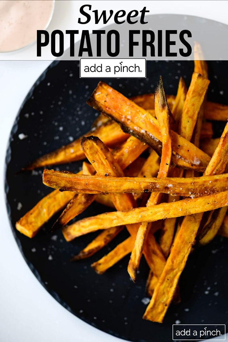 Black plate with sweet potato fries sprinkled with sea salt - with text - addapinch.com