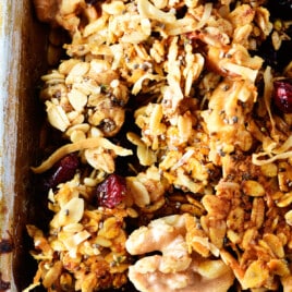 Photo of homemade granola on a baking sheet with a spatula.