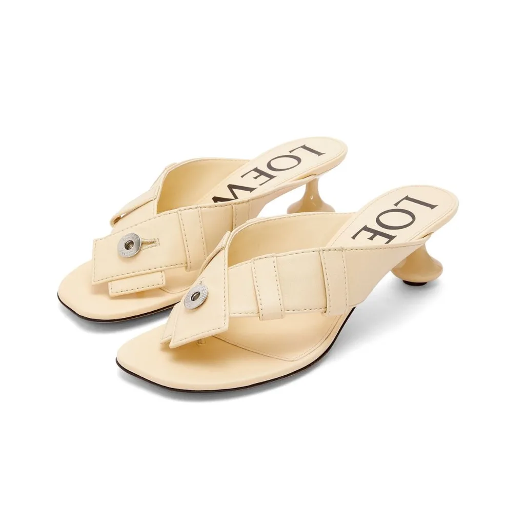 The lambskin leather Loewe Toy Panta thong heel features gladiator style toe straps and the signature patent "toy" heel with a rounded off square toe. 